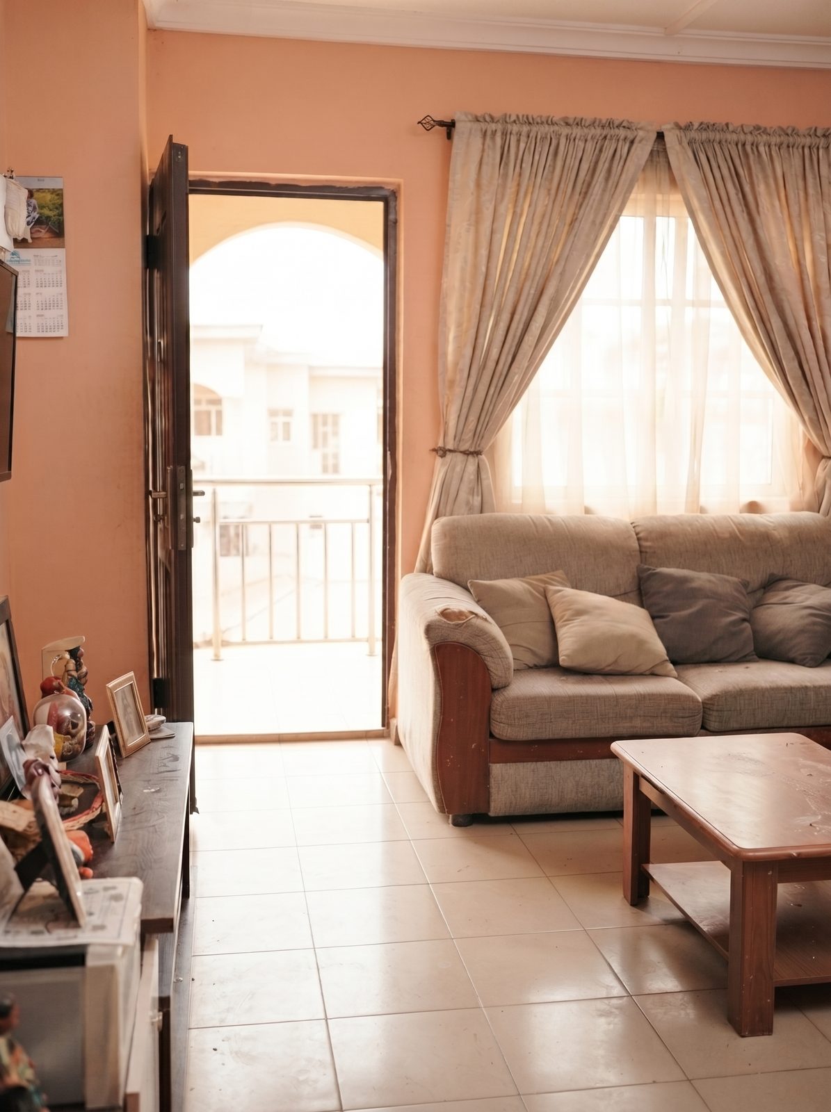 A tidy family living room with clean floors and a made-up sofa after a home clean